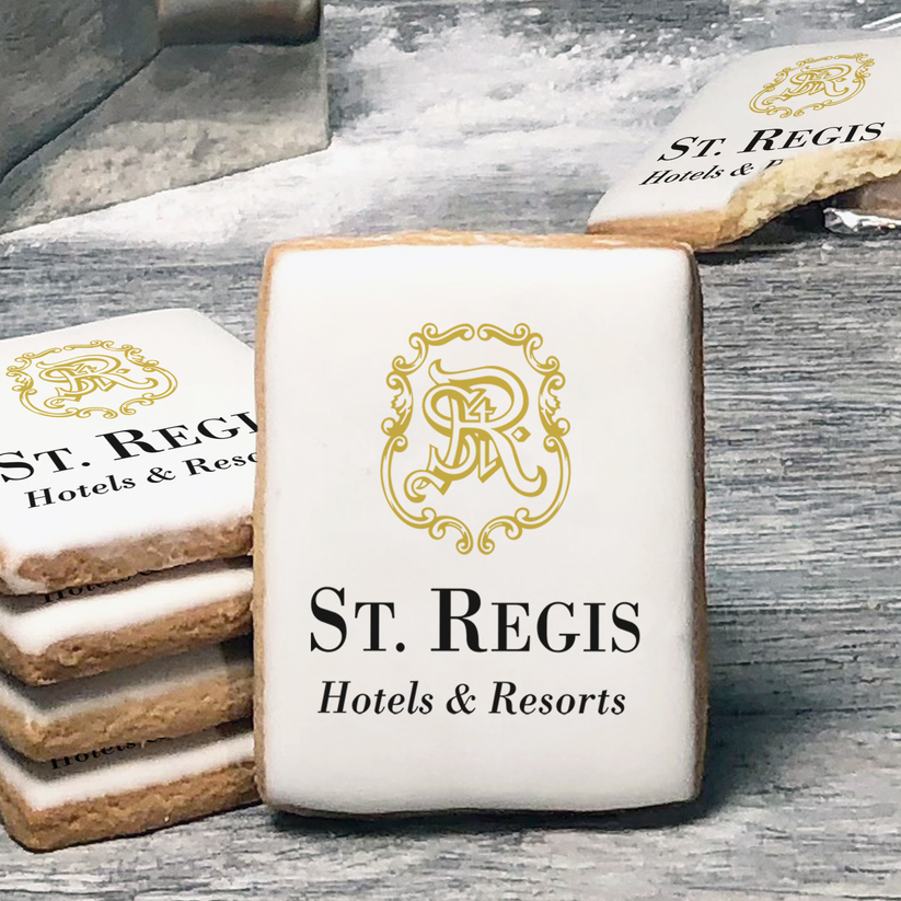 A stack of rectangle butter shortbread cookies with St Regis Hotels & Resorts logo printed directly on a white, lemon sugar icing.