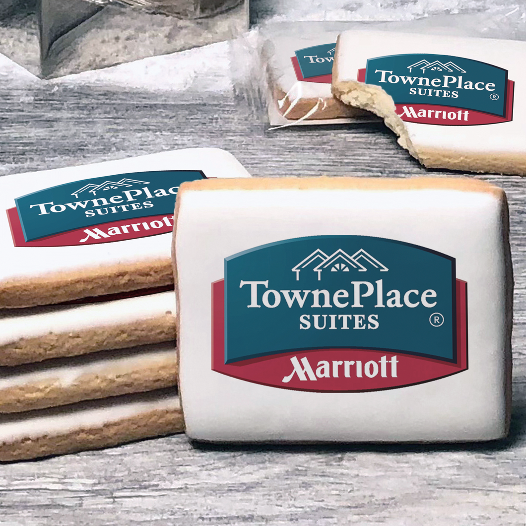 A stack of rectangle butter shortbread cookies with Towneplace Suites logo printed directly on a white, lemon sugar icing.