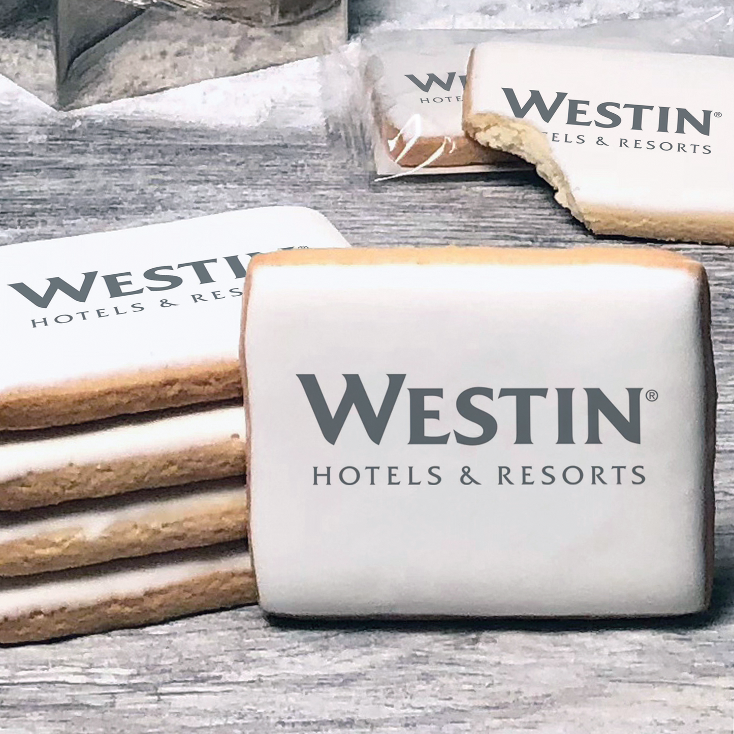 A stack of rectangle butter shortbread cookies with Westin Hotel & Resorts logo printed directly on a white, lemon sugar icing.