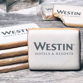 A stack of rectangle butter shortbread cookies with Westin Hotel & Resorts logo printed directly on a white, lemon sugar icing.