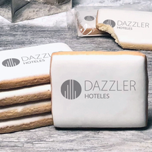 Load image into Gallery viewer, A stack of rectangle butter shortbread cookies with Dazzler logo printed directly on a white, lemon sugar icing.