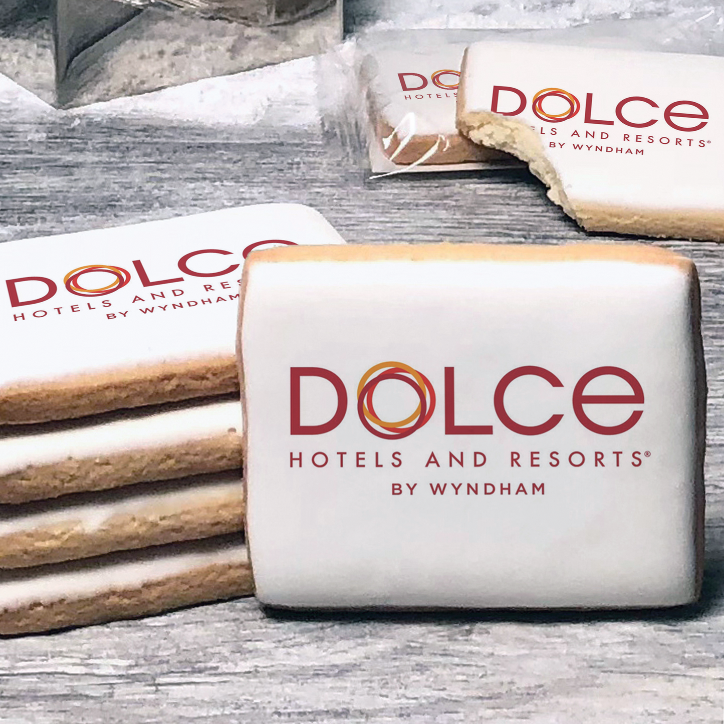 A stack of rectangle butter shortbread cookies with Dolce Hotels & Resorts logo printed directly on a white, lemon sugar icing.