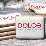 A stack of rectangle butter shortbread cookies with Dolce Hotels & Resorts logo printed directly on a white, lemon sugar icing.