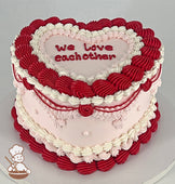 Heart Shaped cake with light-pink smooth icing, decorated with vintage style buttercream piping's in white, red and light-pink colors.