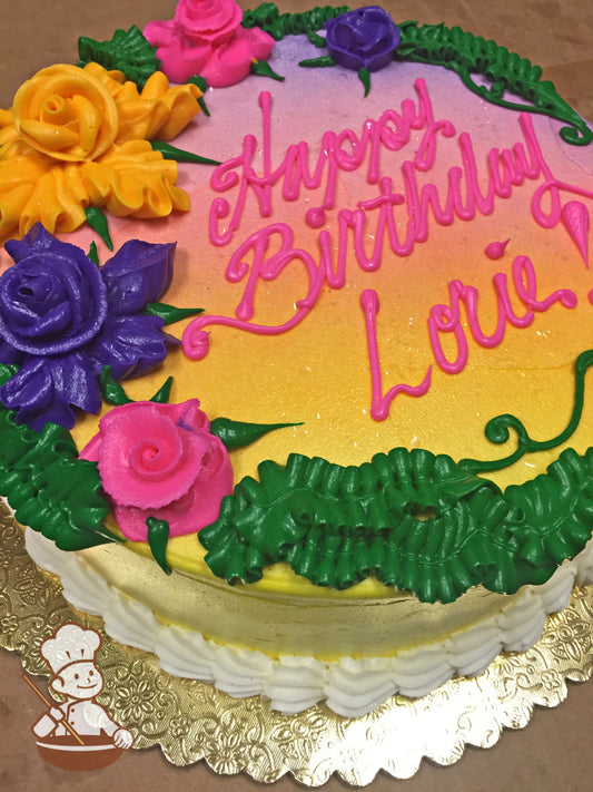 Single tier cake with yellow icing and decorated with buttercream Hawaiian flowers on top of the cake in yellow, purple and pink colors.