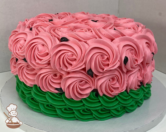 Single tier cake decorated with green and pink buttercream rosette swirls and black buttercream dots to look like a watermelon.