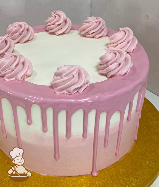 Cake with white and pink icing, and decorated with a pink drip falling over the tier and pink buttercream swirls on top of the cake.