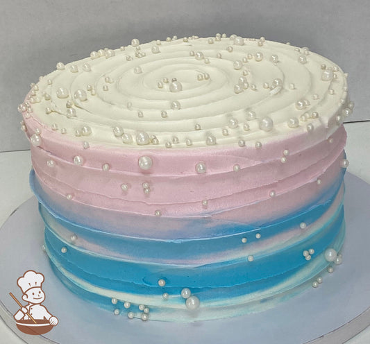 Single tier cake decorated with a pink and blue horizontal texture and white pearls.