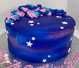 Cake decorated with colored icing to look like a galaxy, multi-colored buttercream swirls on top of the cake with some white fondant stars.