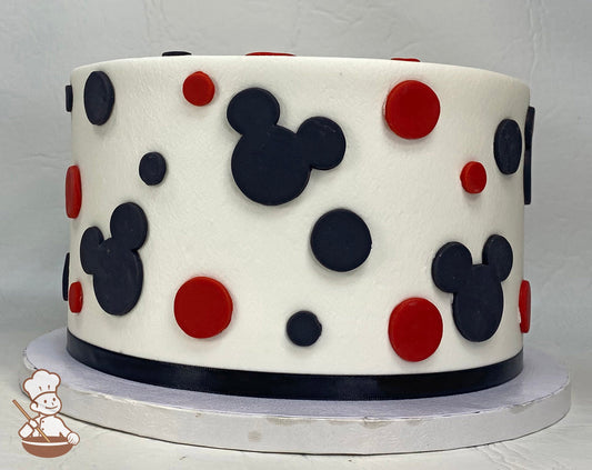 Single tier cake with smooth white icing and decorated with fondant mickey mouse head silhouettes in black and fondant dots in black and red.