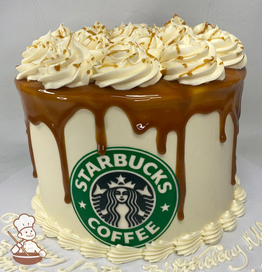 Single tier cake with ivory-colored icing and decorated with a printed image of the Starbucks logo in front of the cake and a caramel drip.