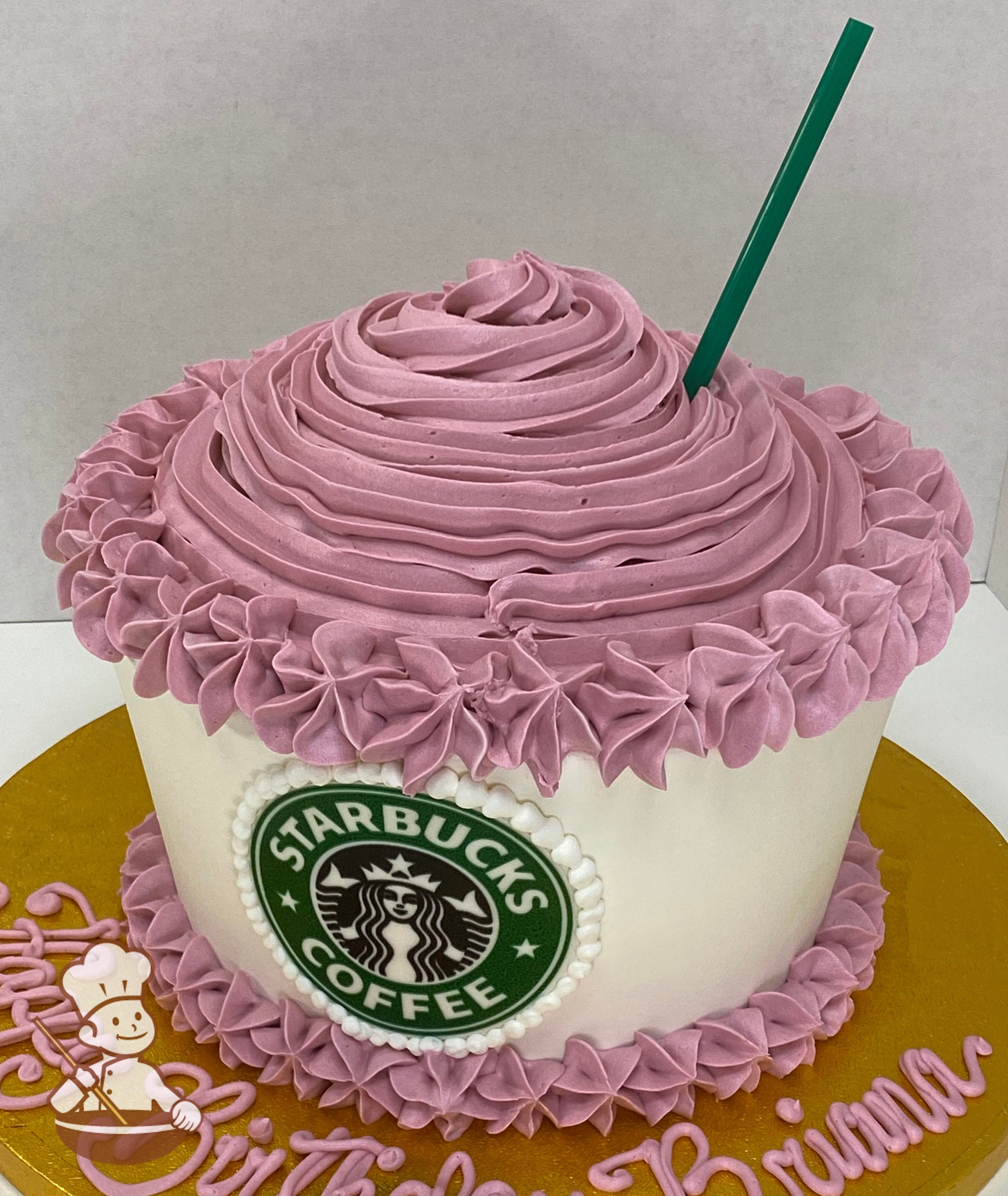 Single tier cake with white icing and decorated with mauve-colored details to look like a Frappuccino with the Starbucks logo in the front.