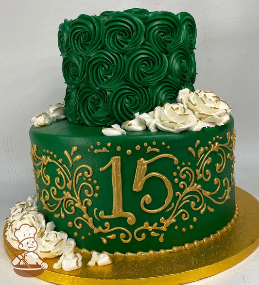 2-tier cake with emerald-green icing and decorated with gold scrolls, a hand-piped 15, emerald-green rosette swirls and white butttercream roses.