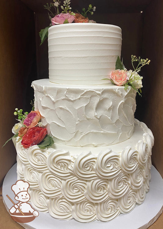 3-tier cake decorated with buttercream rosettes on the bottom tier, stucco-texture in the middle tier and a horizontal texture on the top tier.