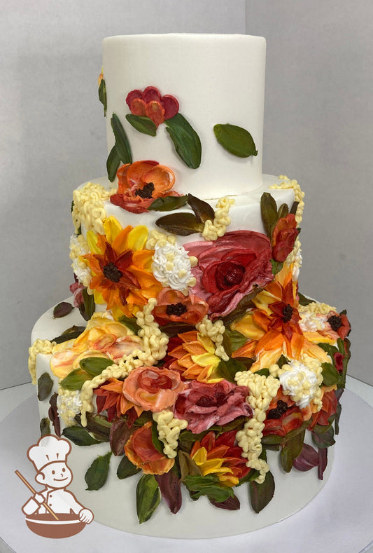 3-tier cake with smooth white icing and decorated with painted buttercream florals in green, orange, red, pink and yellow colors.