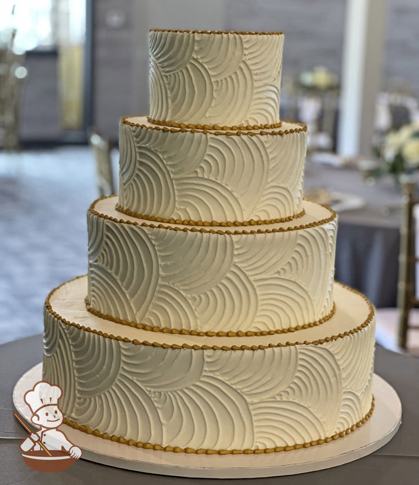 4-tier round cake with smooth white icing and hand-piped white buttercream curved lines all over cake walls and metallic gold trims.