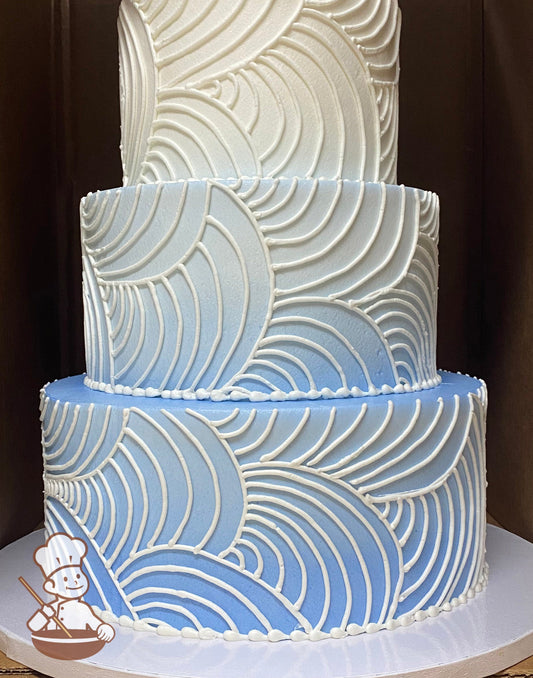 3-tier round cake with smooth icing and hand-piped white buttercream curved lines all over cake walls and periwinkle Ombre airbrushed coloring.