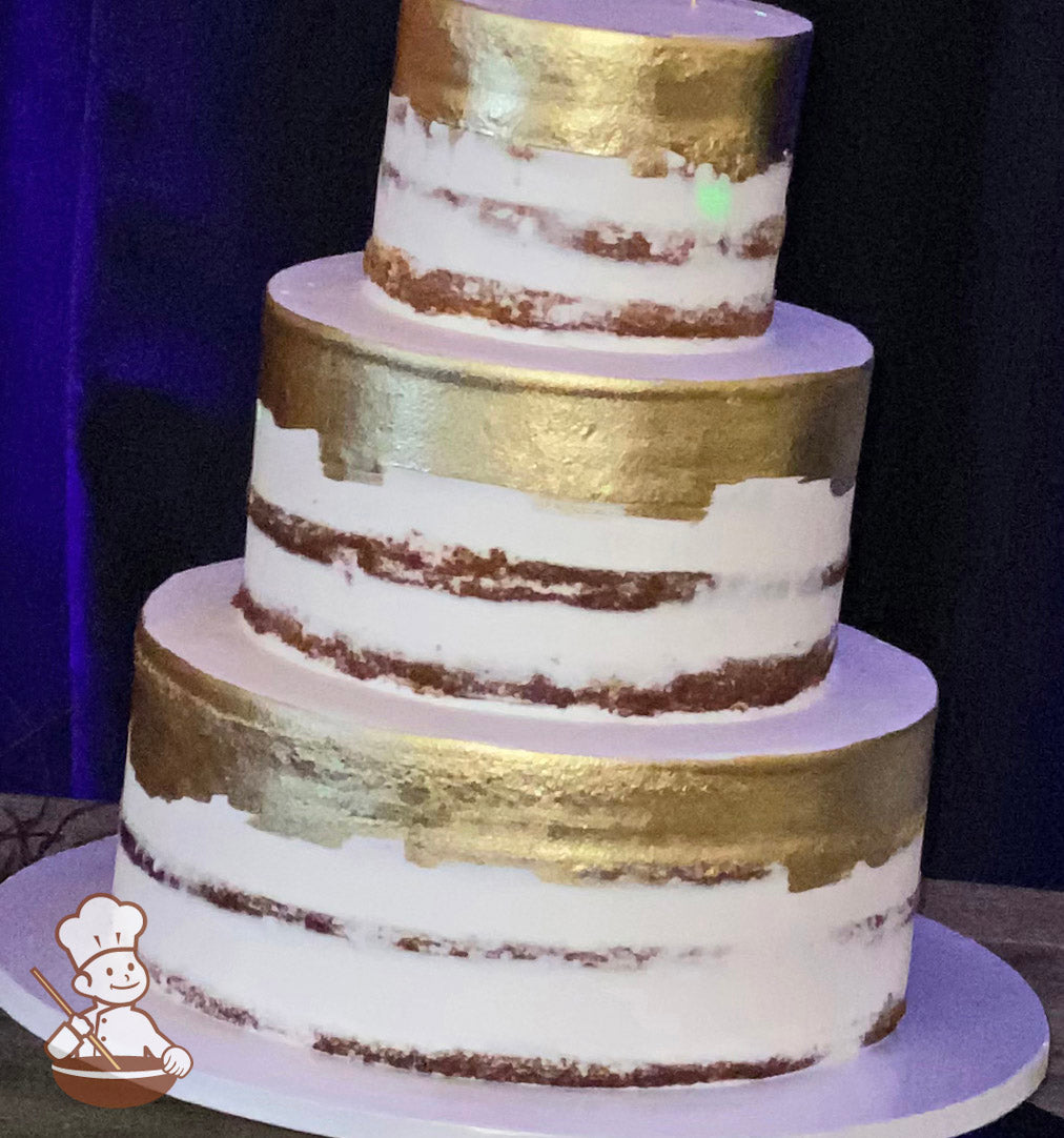 3-tier round cake with white scraped icing to show some of the cake and the top parts of the tiers have been painted gold.
