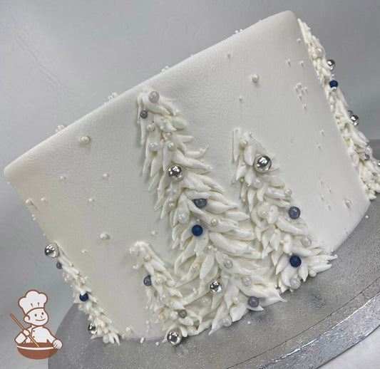 Single tier cake with smooth white icing and buttercream white trees with silver, white, gray and blue sugar pearls.