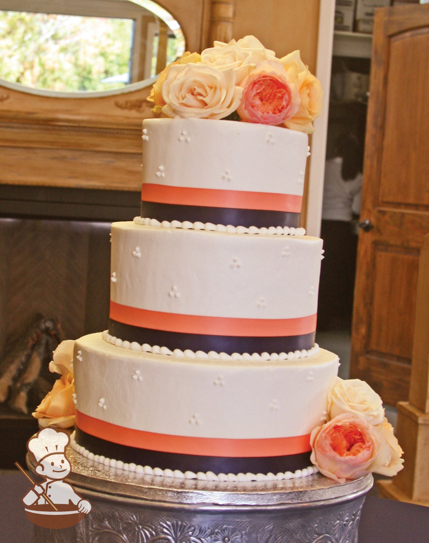3-tier cake with smooth white icing and decorated with white buttercream tridot piping's and a double layer satin ribbon on base of each tier.