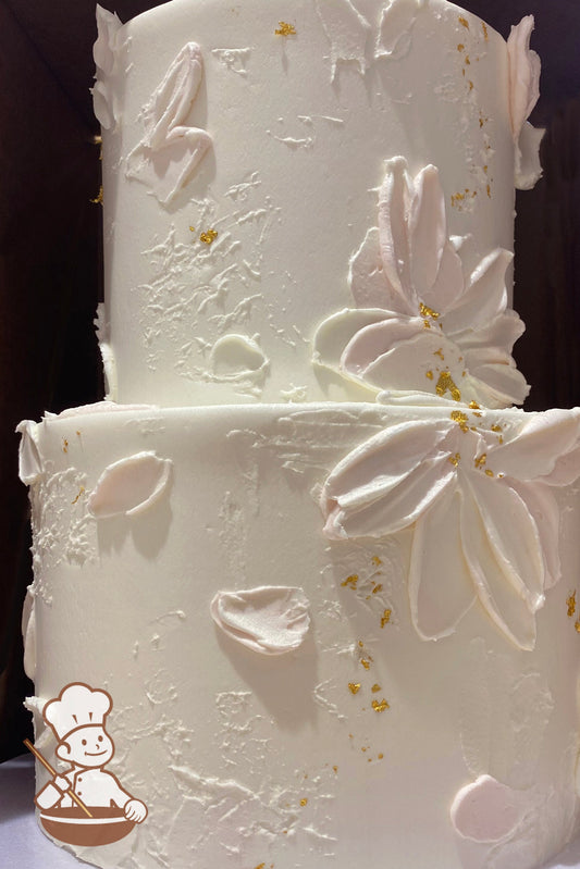 2-tier hand painted baby pink petals on textured cake wall. Decorated with falkes of gold dust.