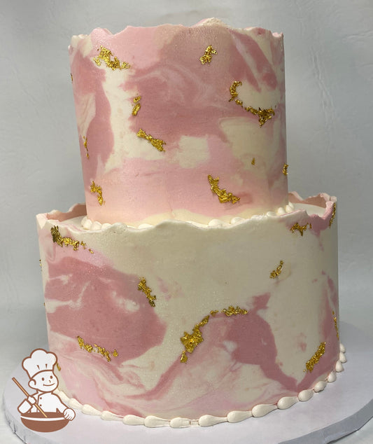 2-tier pink marble cake with unfinished top and gold flakes.