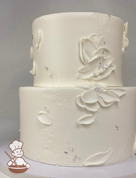 2 tier wedding cake with oil painting style buttercream petals and gold leaf accents.