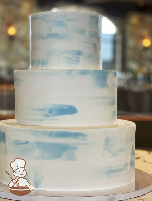 3 tier buttercream wedding cake with light texture dusty blue scraped buttercream pattern.
