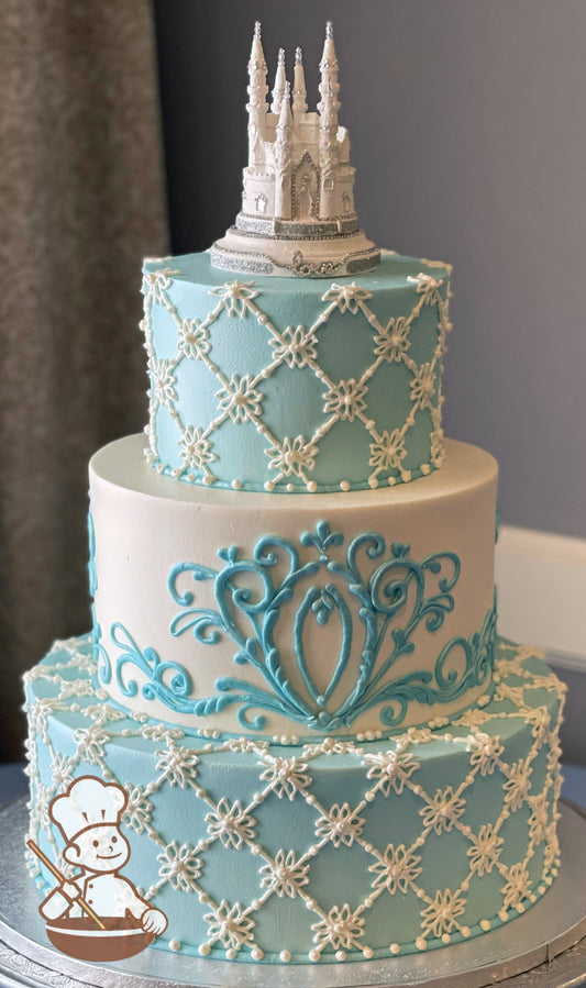 3-tier cake with light-blue icing and white piping's on the bottom and top tier and the middle tier has smooth white icing and blue piping's.