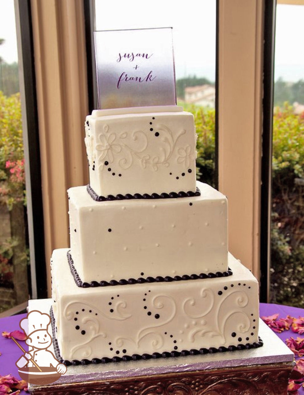 3-tier cake with smooth white icing and decorated with white buttercream scrolls on the bottom and top tier and buttercream dots in middle tier.