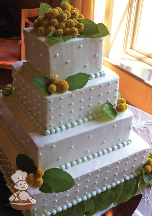 4-tier white cake with smooth icing and decorated with white buttercream dots and a mint-green beaded trim and golden-yellow berries with leaves.