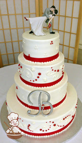 4-tier cake with smooth icing and decorated with white buttercream scrolls, white and red buttercream dots and a red satin ribbon.