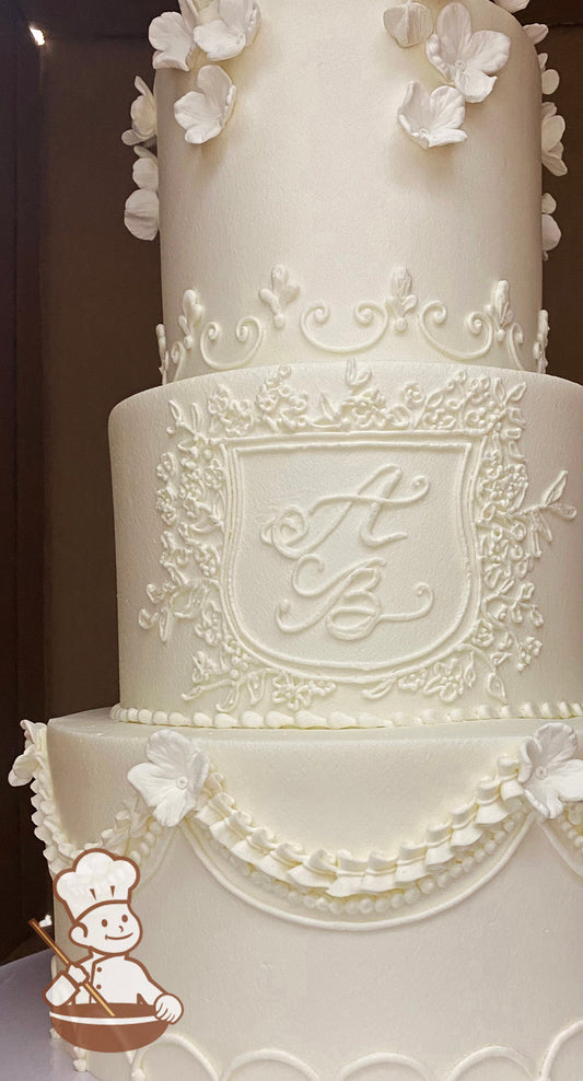 Cake with smooth white icing and decorated with white buttercream piping's on the bottom and top tier and a piped custom monogram in middle.