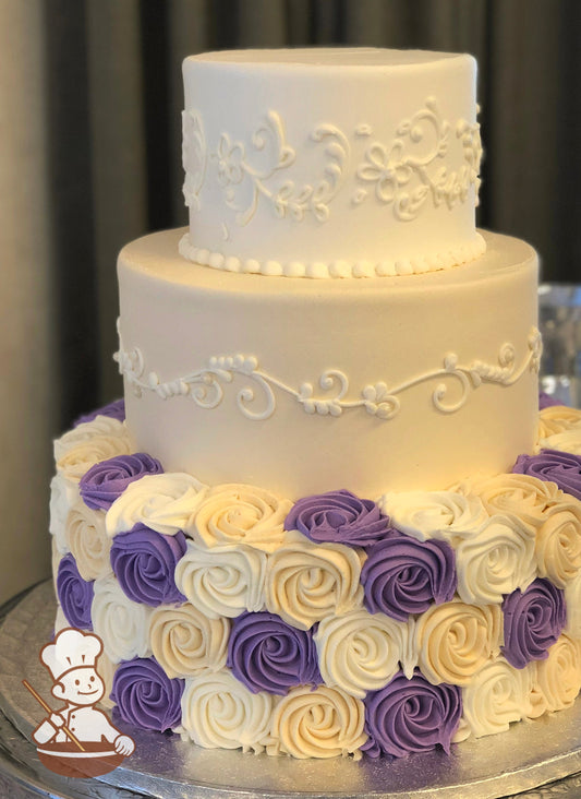 3 tier round cake with multi colored (purple, cream and white) rosette swirls and cream middle tier and white elegant piping design.