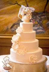 4 tier round wedding cake with sugar crystal cover and decorated with peony sugar flowers and topped with heirloom cake topper.