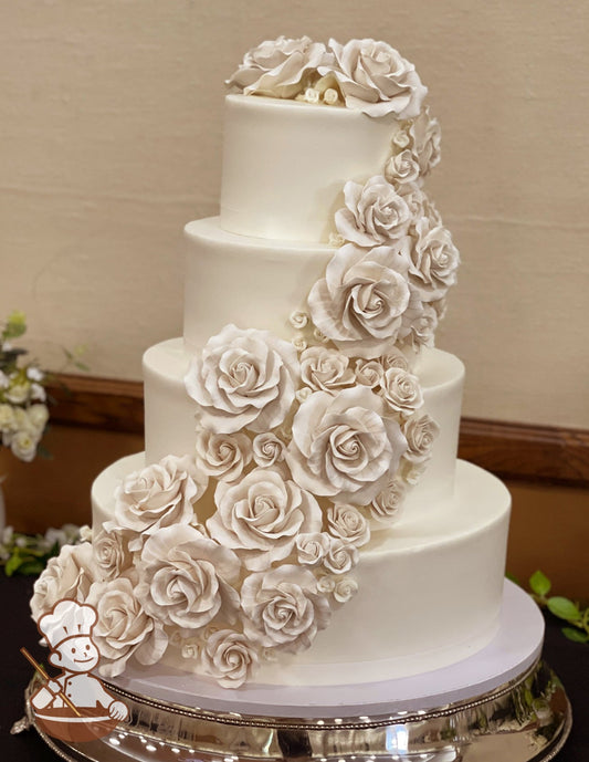 4 tier round wedding cake with smooth buttercream icing and finished with pearlescent shimmered sugar roses.
