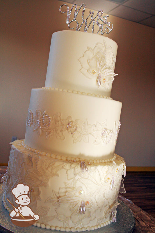 3 Tier Wedding cake with smooth buttercream icing and fabric lace and pearl beads.