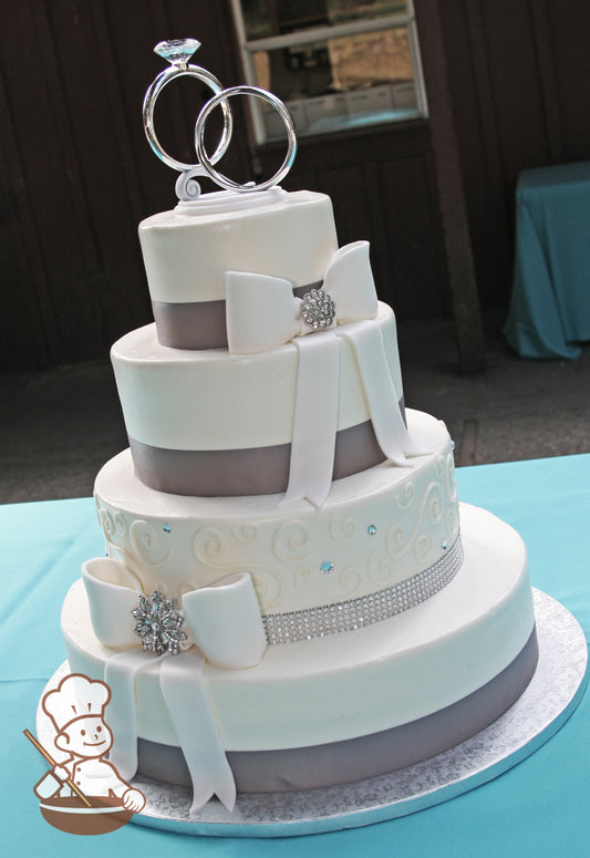 4 tier wedding cake with gray ribbon wrap and white fondant bows with crystal broach centers & finished with traditional piping & rhinestones.