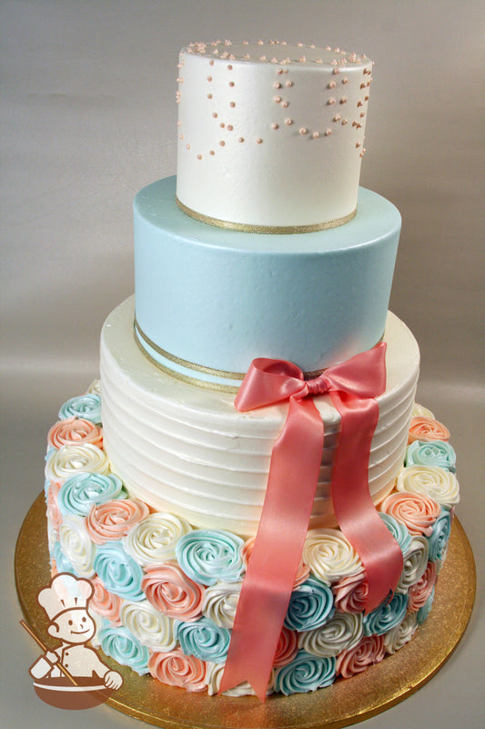 4 tier round wedding cake with coral, blue, and white decorations (rosettes, horizontal texture, bead piping, ribbon bow) and shimmer spray.