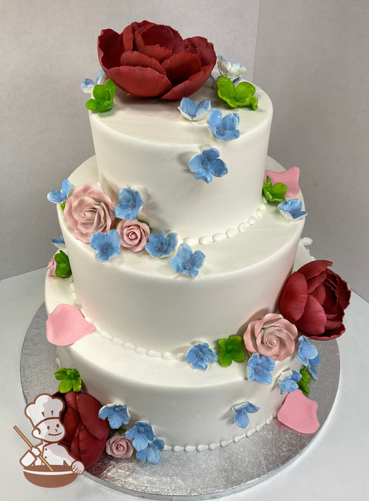 3 tier smooth buttercream wedding cake with sugar flowers (burgundy peonies, dusty pink roses & petals, blue & green hydrangeas).
