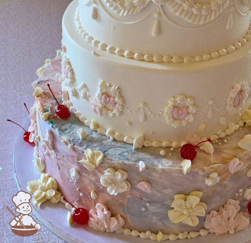 Pastel rainbow texture cake with buttercream flowers and maraschino cherry.  Fondant bows in middle of vintage piping design.