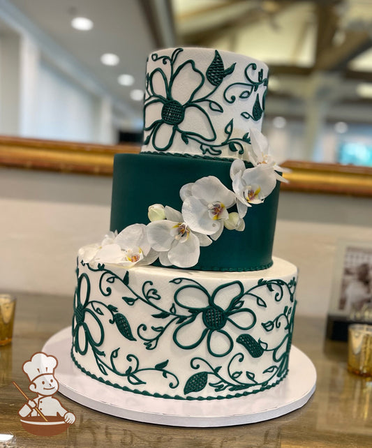 3 tier wedding cake with forest green floral piping on white buttercream top & bottom tier.  Forest Green middle tier cake with orchid flowers.