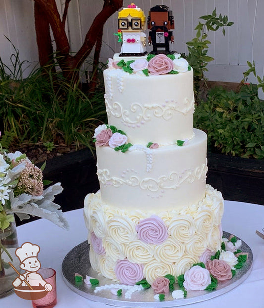 3 tier wedding cake with rosette swirls on bottom tier and traditional piping on top tiers decorated with buttercream roses.