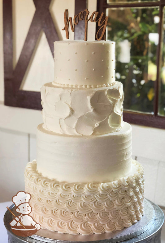 4-tier cake with white icing, decorated with rosettes on the bottom tier, a light horizontal texture on the second tier and dots on the top tier.