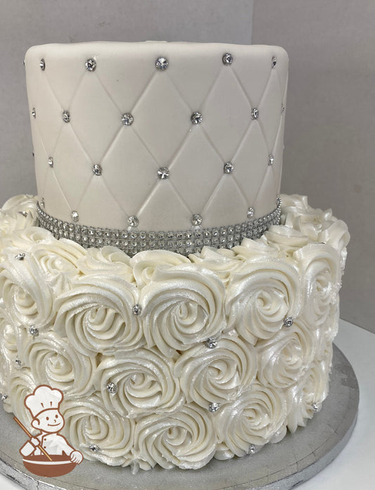 2 tier wedding cake with rosette swirl on bottom tier and quilted fondant pattern with rhinestones on top tier and finished with a shimmer spray.