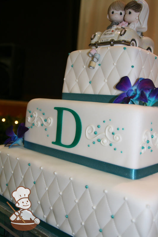 3 tier square fondant wedding cake with quilted pillow fondant pattern and fondant monogram with beaded pipings.