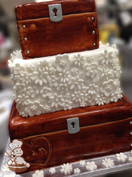 3 tier square wedding cake with fondant wood locket box design on top & bottom tier with fondant flowers in middle tier.