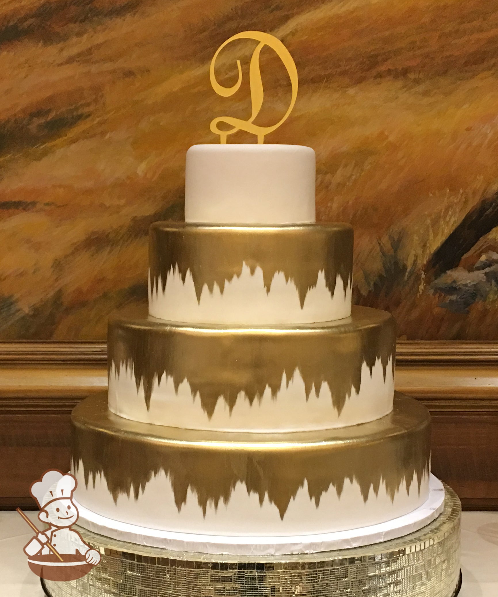4 tier fondant wedding cake with gold design.