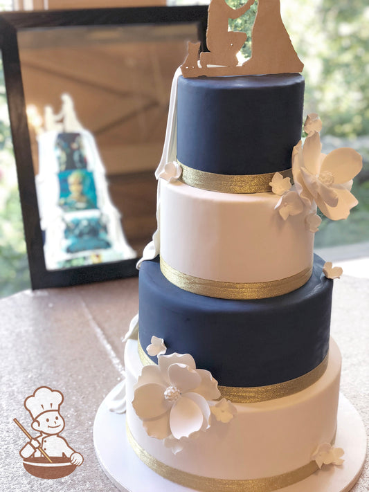 Round fondant wedding cake with alternating white and navy blue tiers. One side decorated with comic book characters and the other sugar flowers.