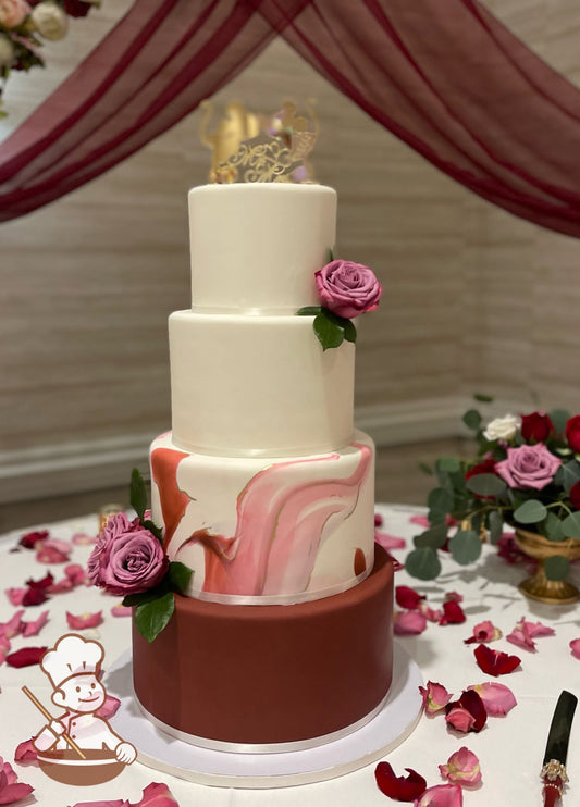 Round fondant wedding cake with burgundy bottom tier and burgundy marbled 2nd tier painted with gold accents. Smooth white top 2 tiers & flowers.